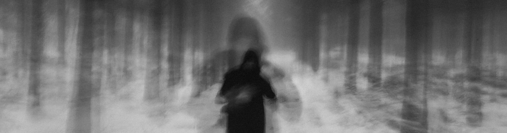 a blurry photo of a person walking in the snow